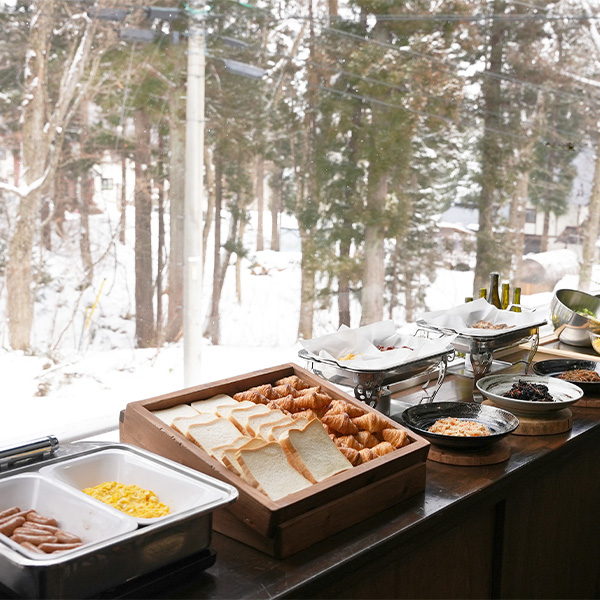 雪景色の窓辺に並ぶ朝食